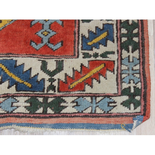 201 - A vintage multi-coloured hand knotted rug, likely Turkish, approx 153cm x 102cm