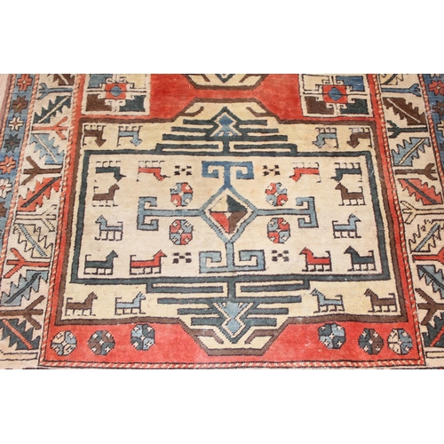 202 - A vintage multi-coloured hand knotted rug decorated with animals, possibly a Turkish Izmir rug, appr... 