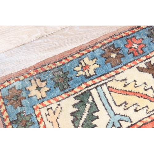 202 - A vintage multi-coloured hand knotted rug decorated with animals, possibly a Turkish Izmir rug, appr... 