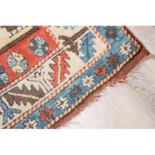 202 - A vintage multi-coloured hand knotted rug decorated with animals, possibly a Turkish Izmir rug, appr... 