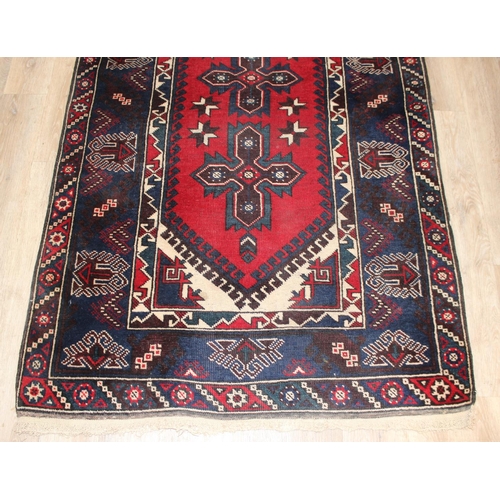 203 - A vintage Turkish rug of red and dark blue ground, believed to be a Yoruk Dosemealti, approx 215cm x... 