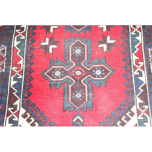 203 - A vintage Turkish rug of red and dark blue ground, believed to be a Yoruk Dosemealti, approx 215cm x... 