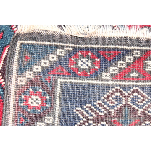 203 - A vintage Turkish rug of red and dark blue ground, believed to be a Yoruk Dosemealti, approx 215cm x... 