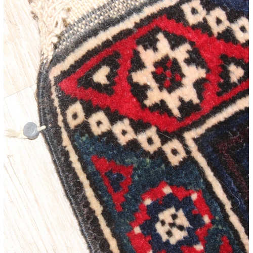 203 - A vintage Turkish rug of red and dark blue ground, believed to be a Yoruk Dosemealti, approx 215cm x... 