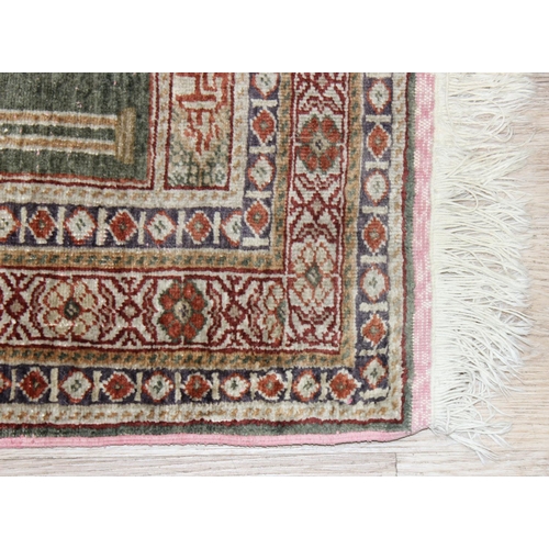 205 - A vintage Turkish prayer rug of faded blue ground, believed to be a silk Kayseri rug, approx 110cm x... 