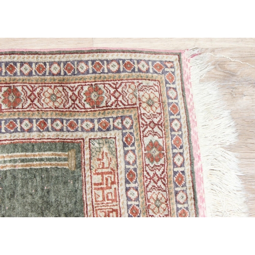 205 - A vintage Turkish prayer rug of faded blue ground, believed to be a silk Kayseri rug, approx 110cm x... 