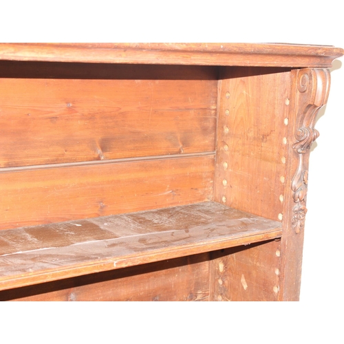 134 - An antique oak bookcase with 3 adjustable shelves and carved strapwork details, approx 122cm wide x ... 