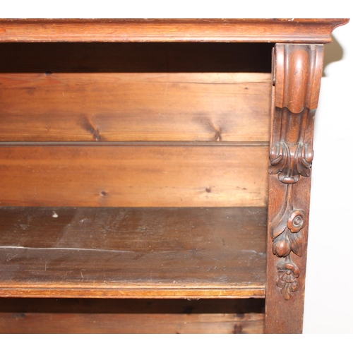 134 - An antique oak bookcase with 3 adjustable shelves and carved strapwork details, approx 122cm wide x ... 