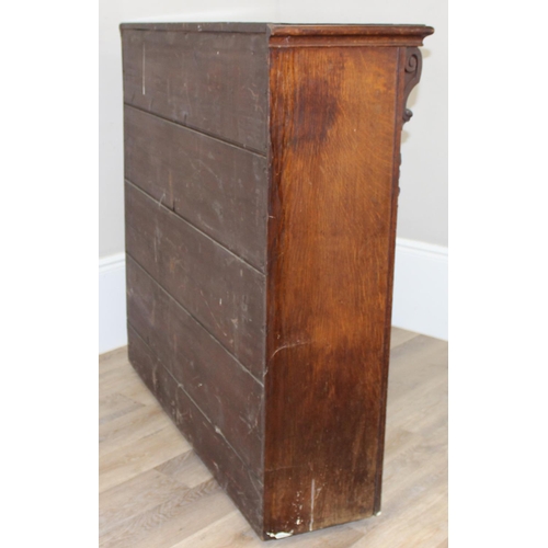 134 - An antique oak bookcase with 3 adjustable shelves and carved strapwork details, approx 122cm wide x ... 