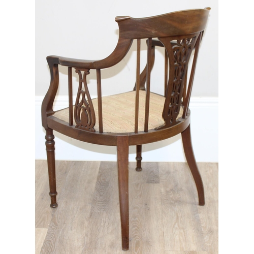 125 - An Edwardian mahogany tub chair with pierced fretwork back, inlaid details and reeded legs, approx 5... 