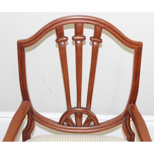 48 - A pair of 20th century hardwood armchairs, believed to be from Hong Kong, with carved shield shaped ... 