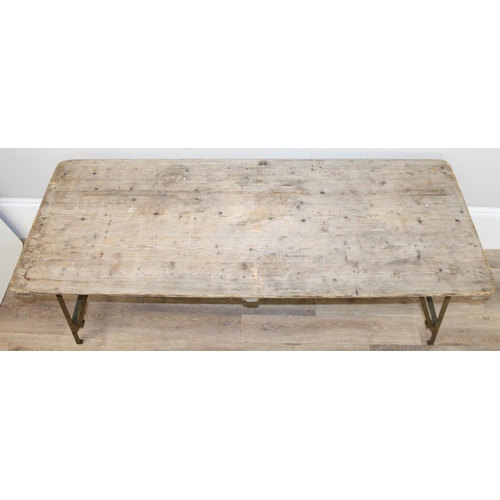 108 - A vintage weathered pine trestle table with folding metal legs, mid-late 20th century, approx 178cm ... 