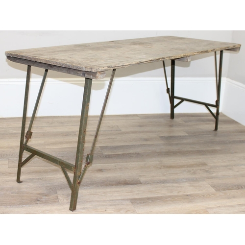 108 - A vintage weathered pine trestle table with folding metal legs, mid-late 20th century, approx 178cm ... 