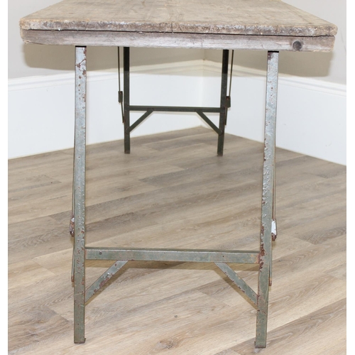 108 - A vintage weathered pine trestle table with folding metal legs, mid-late 20th century, approx 178cm ... 