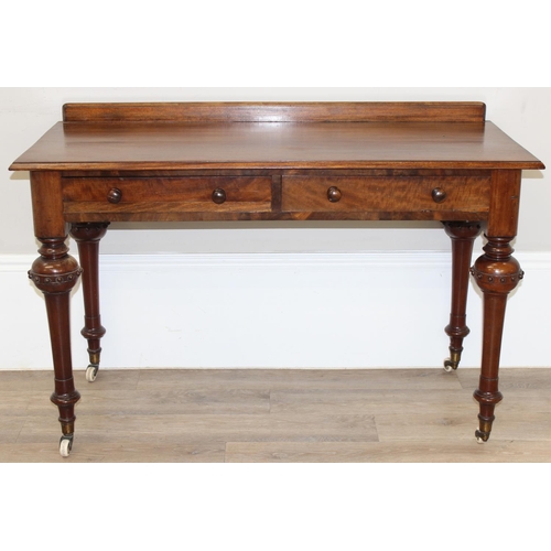 137 - A superb quality Victorian mahogany desk or side table with 2 drawers, standing on unusual legs deco... 