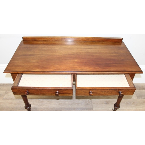 137 - A superb quality Victorian mahogany desk or side table with 2 drawers, standing on unusual legs deco... 