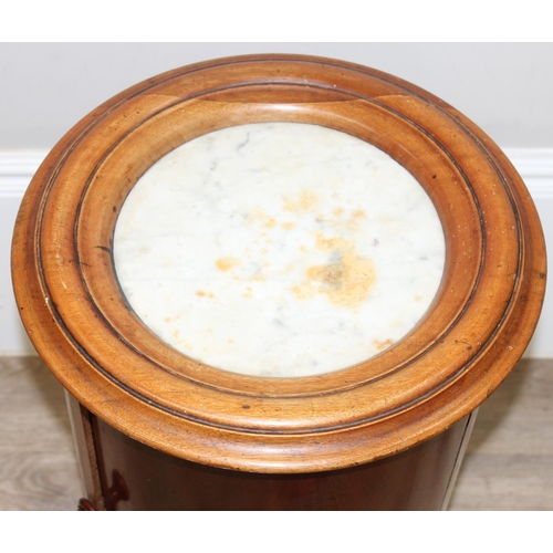 128 - An antique round mahogany pot cupboard with marble top, a single drawer opening to reveal 2 shelves,... 