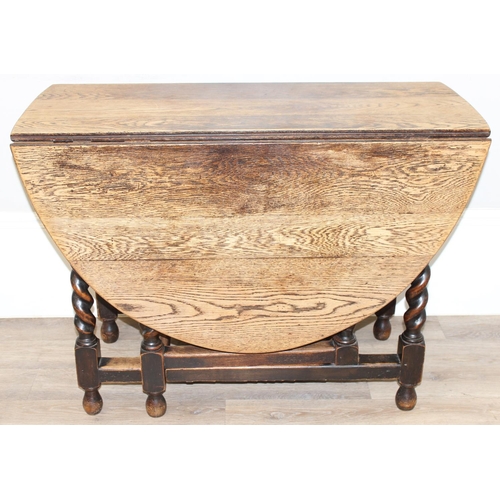 127 - An early 20th century oak drop leaf table with barley-twist legs, approx 107cm wide x 49cm deep (ext... 