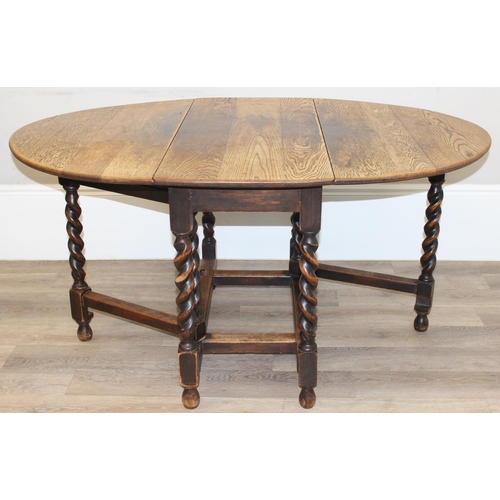 127 - An early 20th century oak drop leaf table with barley-twist legs, approx 107cm wide x 49cm deep (ext... 