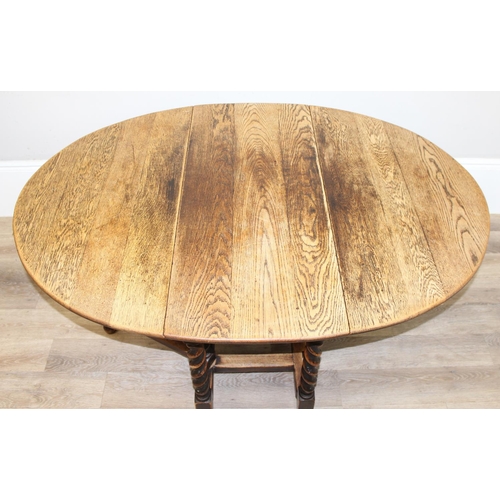 127 - An early 20th century oak drop leaf table with barley-twist legs, approx 107cm wide x 49cm deep (ext... 