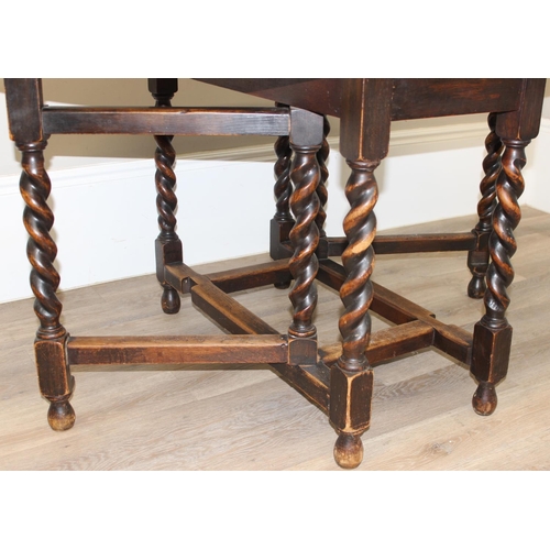 127 - An early 20th century oak drop leaf table with barley-twist legs, approx 107cm wide x 49cm deep (ext... 