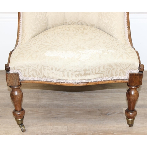 29 - An antique mahogany framed slipper chair with exposed carved wooden frame and buttoned cream upholst... 