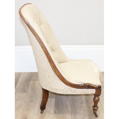 29 - An antique mahogany framed slipper chair with exposed carved wooden frame and buttoned cream upholst... 