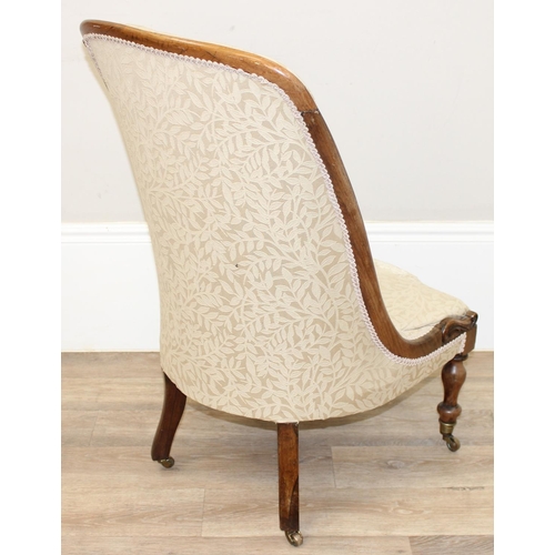 29 - An antique mahogany framed slipper chair with exposed carved wooden frame and buttoned cream upholst... 