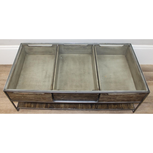 49 - An unusual industrial style reclaimed wooden, metal and glass bijouterie coffee table, the 3 drawers... 