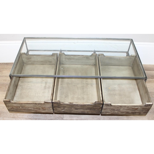 49 - An unusual industrial style reclaimed wooden, metal and glass bijouterie coffee table, the 3 drawers... 