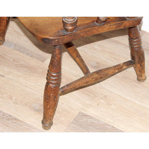 60 - An antique slat backed Windsor farmhouse armchair with elm seat, approx 61cm wide x 103cm tall