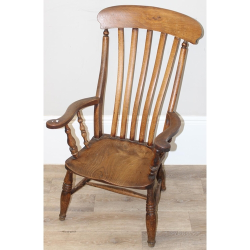 60 - An antique slat backed Windsor farmhouse armchair with elm seat, approx 61cm wide x 103cm tall