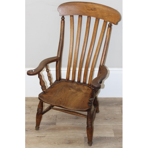 60 - An antique slat backed Windsor farmhouse armchair with elm seat, approx 61cm wide x 103cm tall