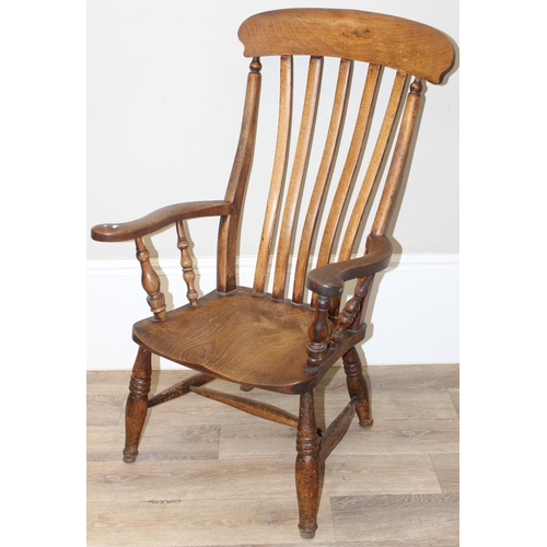 60 - An antique slat backed Windsor farmhouse armchair with elm seat, approx 61cm wide x 103cm tall