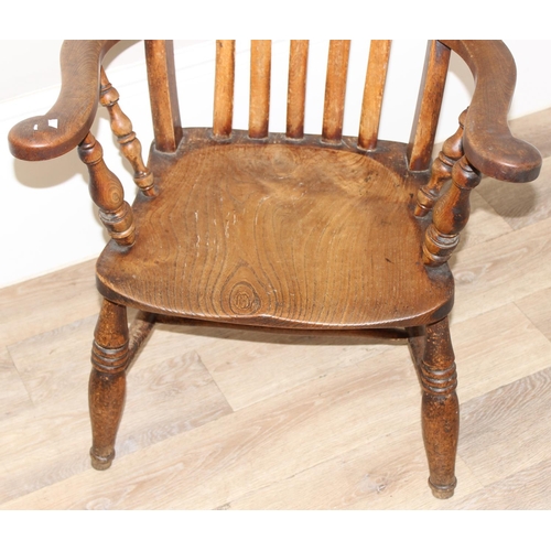 60 - An antique slat backed Windsor farmhouse armchair with elm seat, approx 61cm wide x 103cm tall