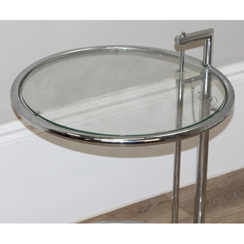 9 - In the manner of Eileen Grey, a retro adjustable side table with glass top and tubular steel frame, ... 