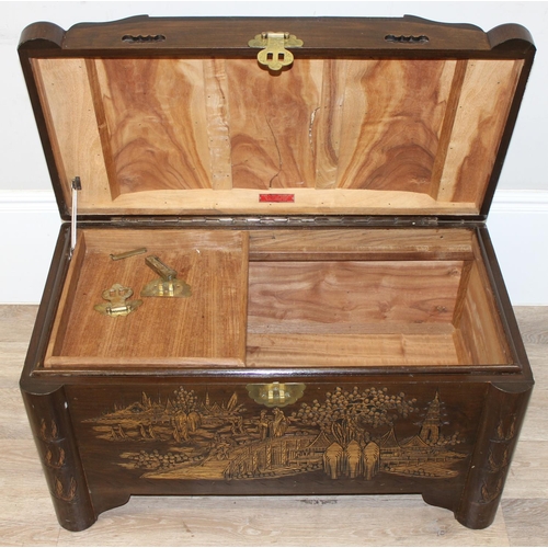 85 - A vintage Oriental camphorwood trunk with carved details and brass mounts, label for Foo Hing of Sin... 