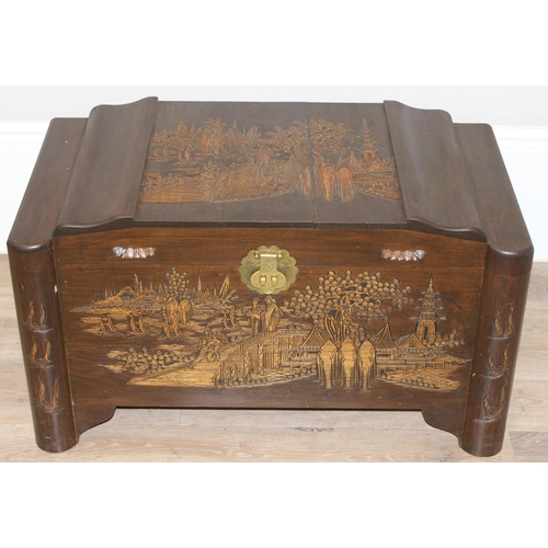 85 - A vintage Oriental camphorwood trunk with carved details and brass mounts, label for Foo Hing of Sin... 