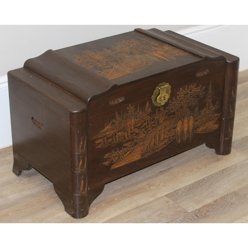 85 - A vintage Oriental camphorwood trunk with carved details and brass mounts, label for Foo Hing of Sin... 