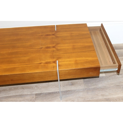 54 - A retro coffee table with figured wooden top and unusual inset metal legs, each end with 2 drawers, ... 