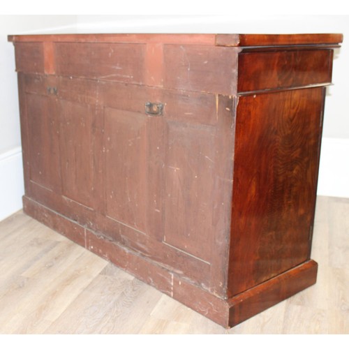 35 - A Victorian mahogany breakfront sideboard, 2 side cupboards flanking a central cupboard, one of the ... 