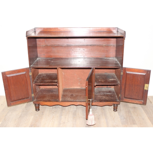 25 - An antique mahogany side hall stand or sideboard of unusual construction, an open recess under a she... 