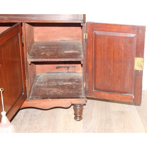 25 - An antique mahogany side hall stand or sideboard of unusual construction, an open recess under a she... 