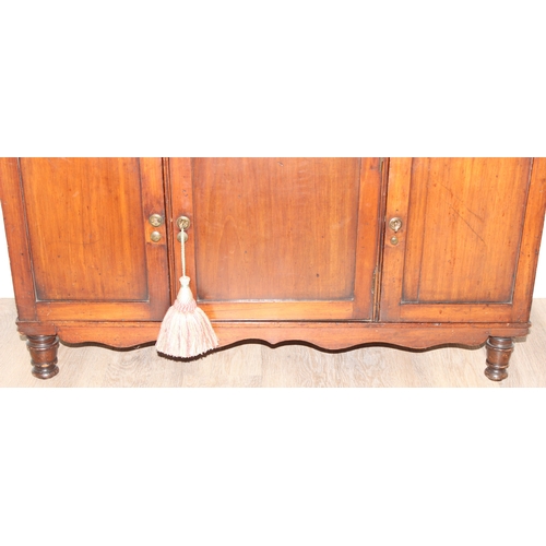 25 - An antique mahogany side hall stand or sideboard of unusual construction, an open recess under a she... 