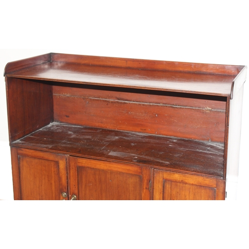 25 - An antique mahogany side hall stand or sideboard of unusual construction, an open recess under a she... 