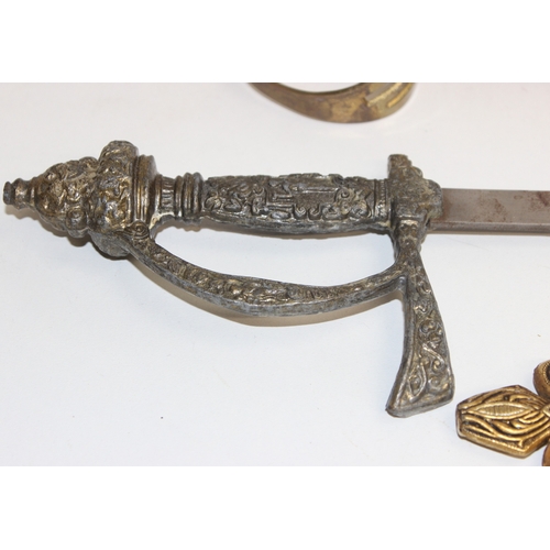 1413 - An Indian brass-hilted sword in red velvet scabbard, two Spanish tourist type large and small decora... 