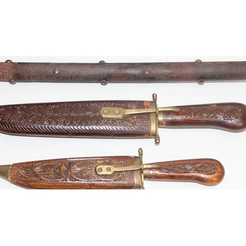 1414 - Replica battle-axe (approx 50cm), 3 Indian wood-mounted daggers of various sizes, 2 small Indian dag... 