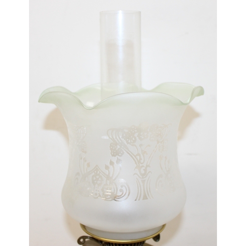 233 - An antique oil lamp with acid etched Art Nouveau glass shade, an embossed brass reservoir, brass col... 