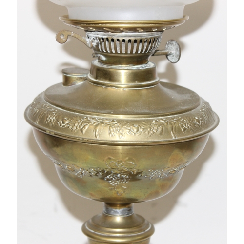 233 - An antique oil lamp with acid etched Art Nouveau glass shade, an embossed brass reservoir, brass col... 