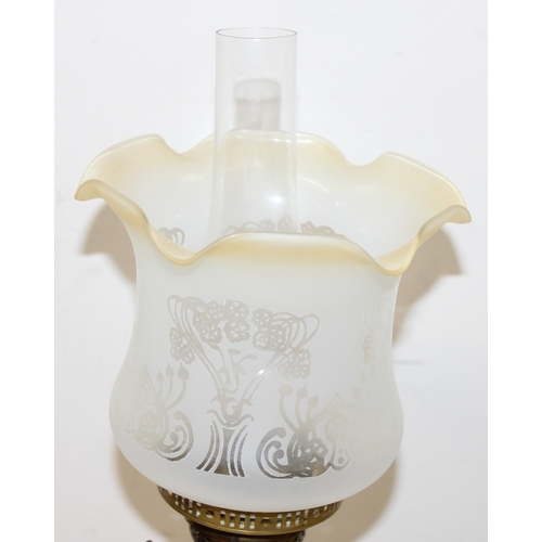 235 - An antique oil lamp with acid etched Art Nouveau glass shade, a brass reservoir, brass column, and a... 